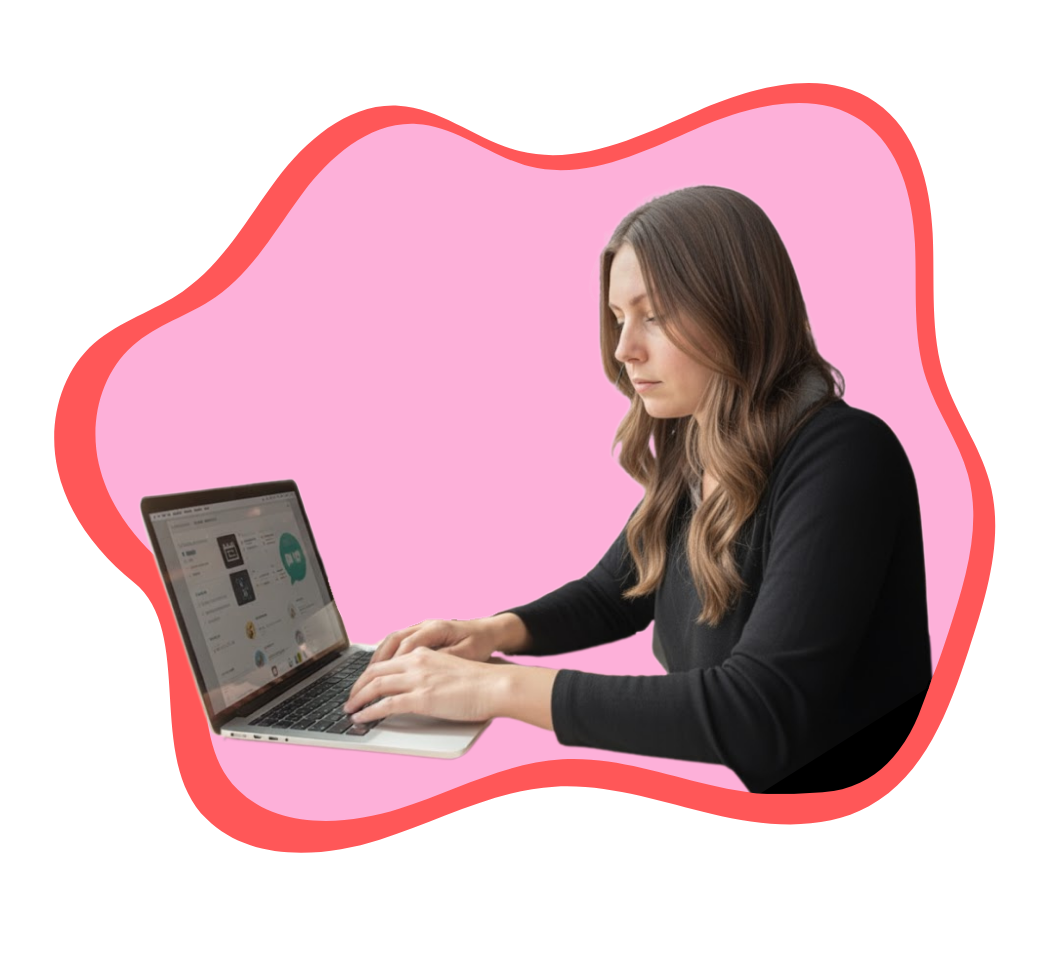 woman smiling while working on a laptop